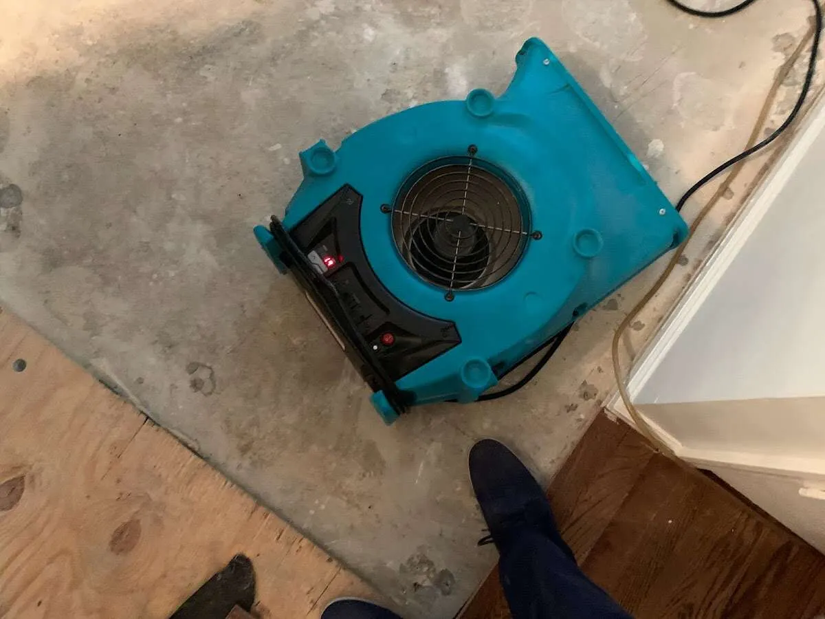 Air mover drying subfloor during Leak Detection & Repair in Streetsboro